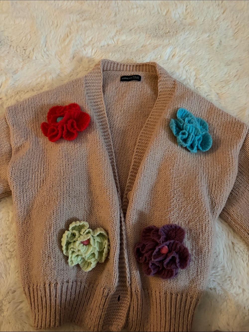 Timeless blush-pink knit cardigan with floral appliqués